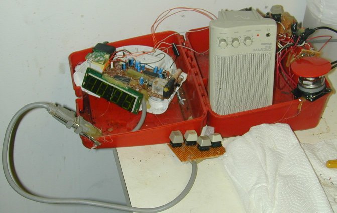 Alarm clock with case removed, wired to an amplifyer with aditional delay circuitry
